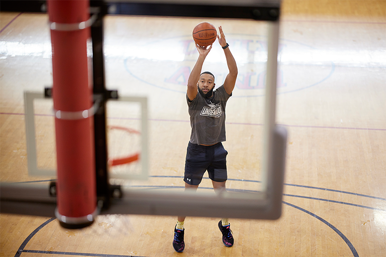 person shooting a basketball midair 