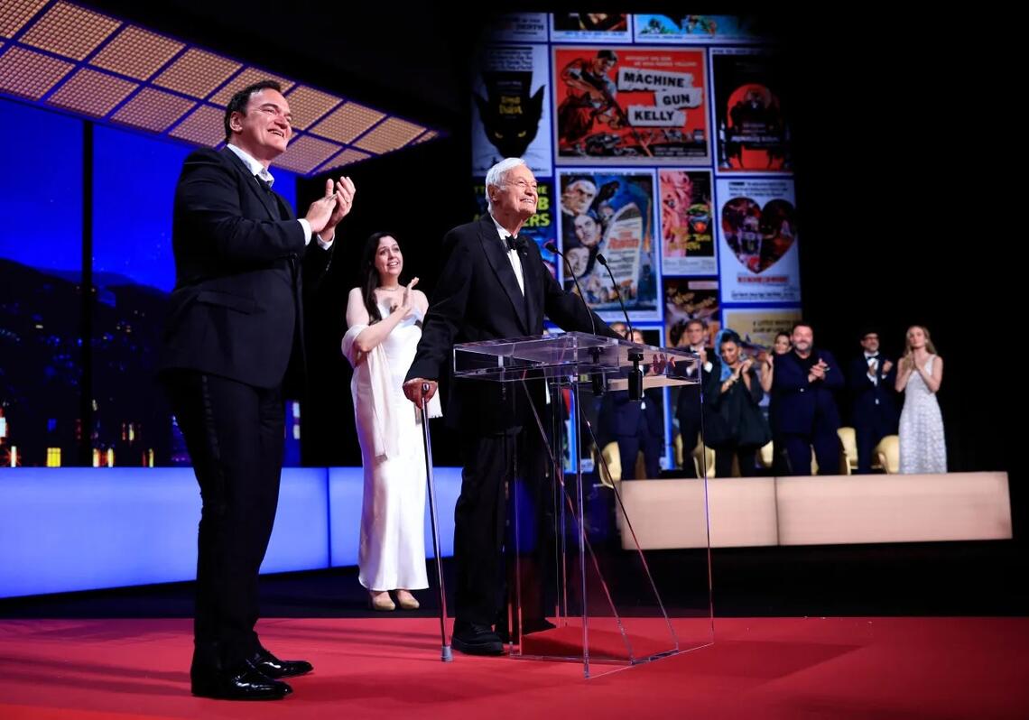 Roger Corman stands on stage with Quentin Tarantino as he arrives to award the Grand Prix during the closing ceremony of the 76th edition of the Cannes Film Festival.