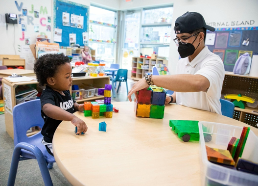 Man playing with blocks with child