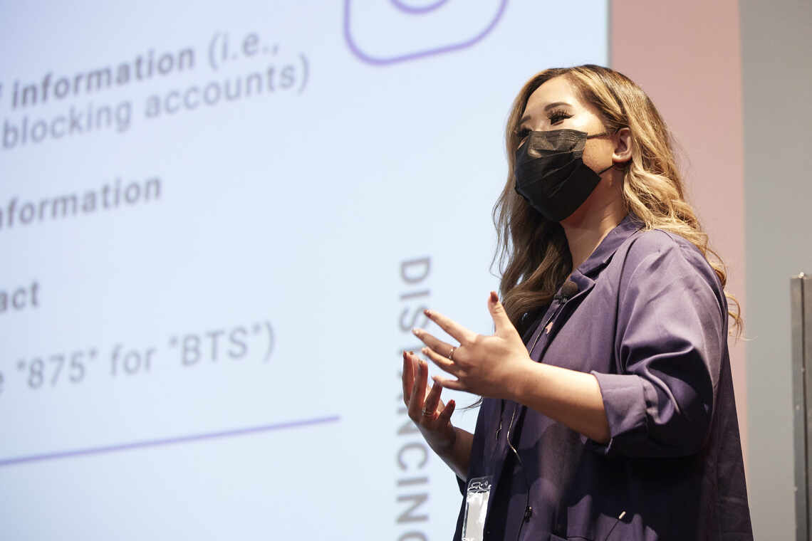 Woman lecturing in front of a projector 