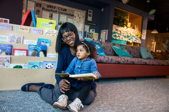 Woman reading book to child