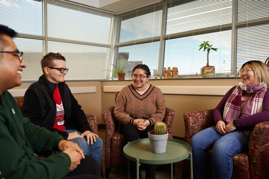 Four people sitting together and talking