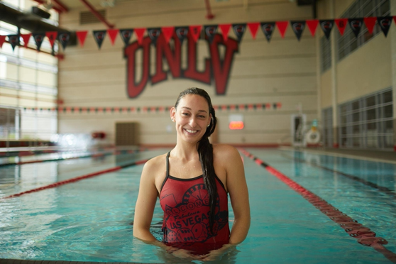 Woman standing in pool with swimsuit on