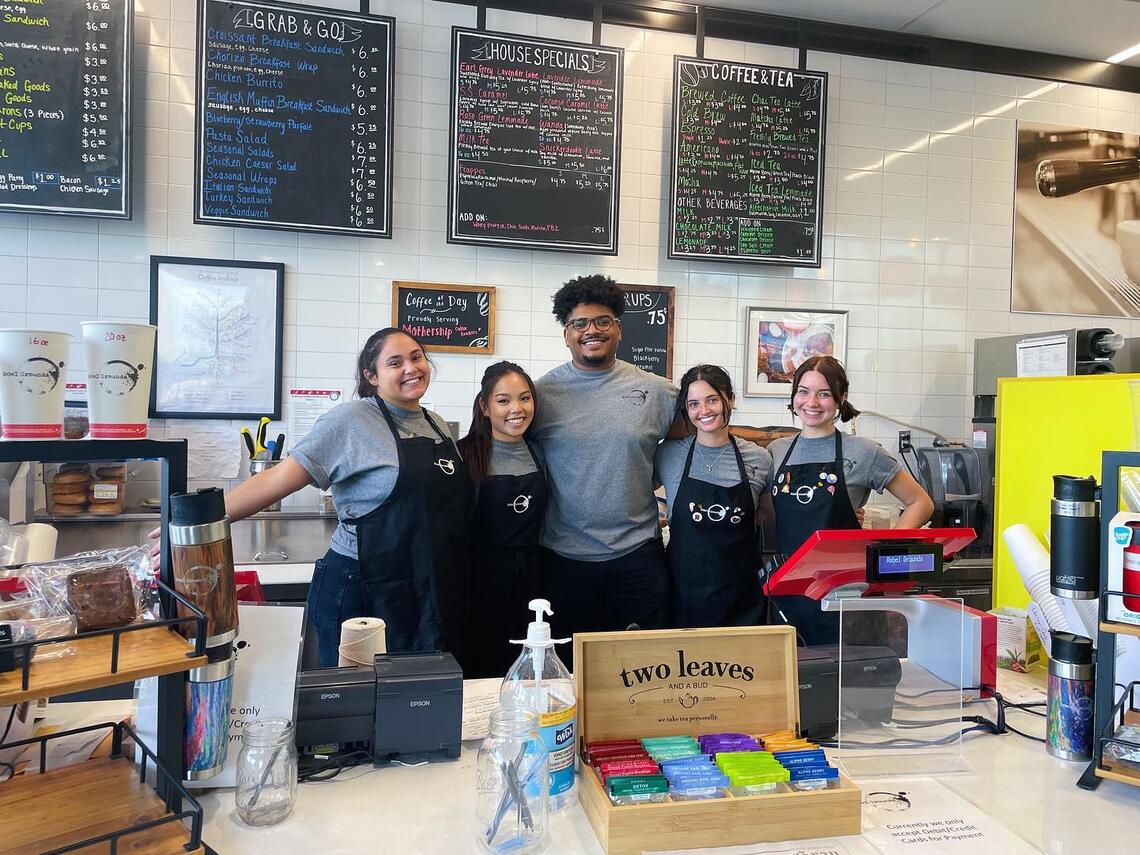 Hospitality students pose for photo while working in student-run coffee cafe.