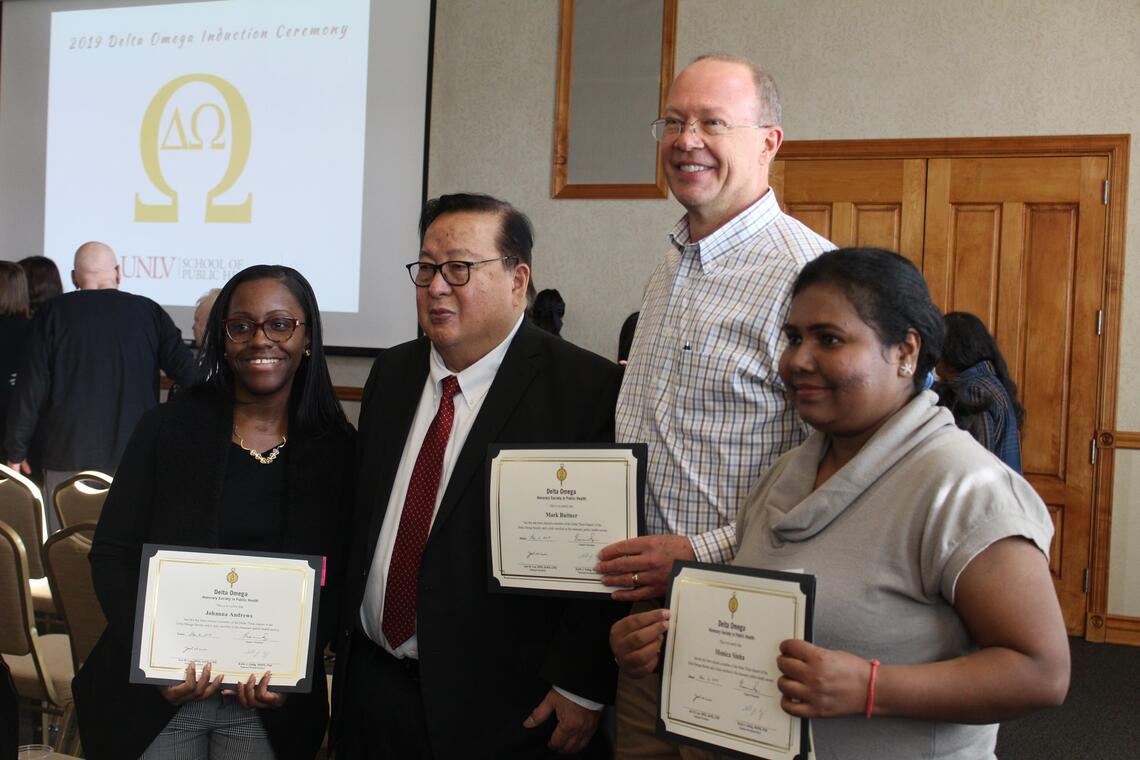 people displaying certificates in an event 