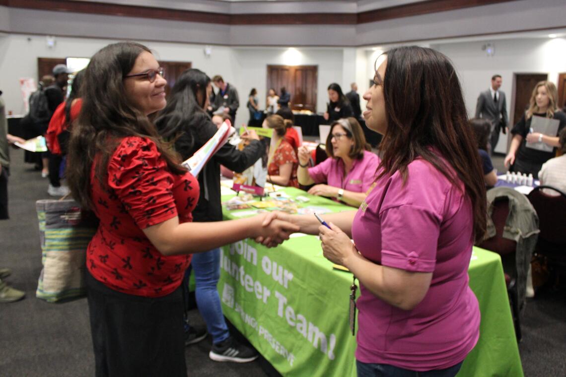 two people shaking hands in a table event