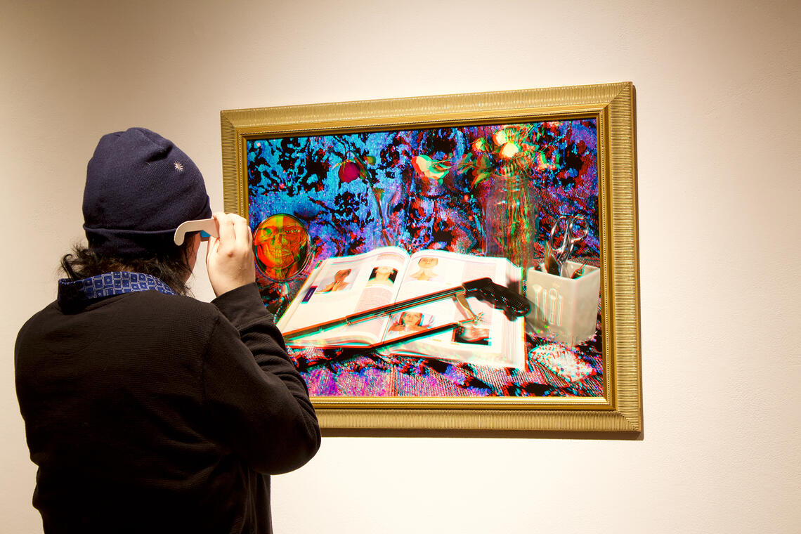 person wearing 3D glasses while looking at 3D art 