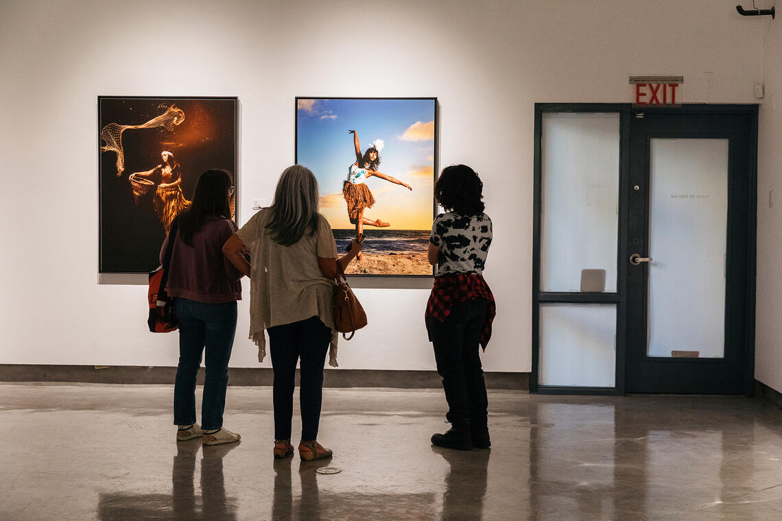 gallery audience looking at art art canvases