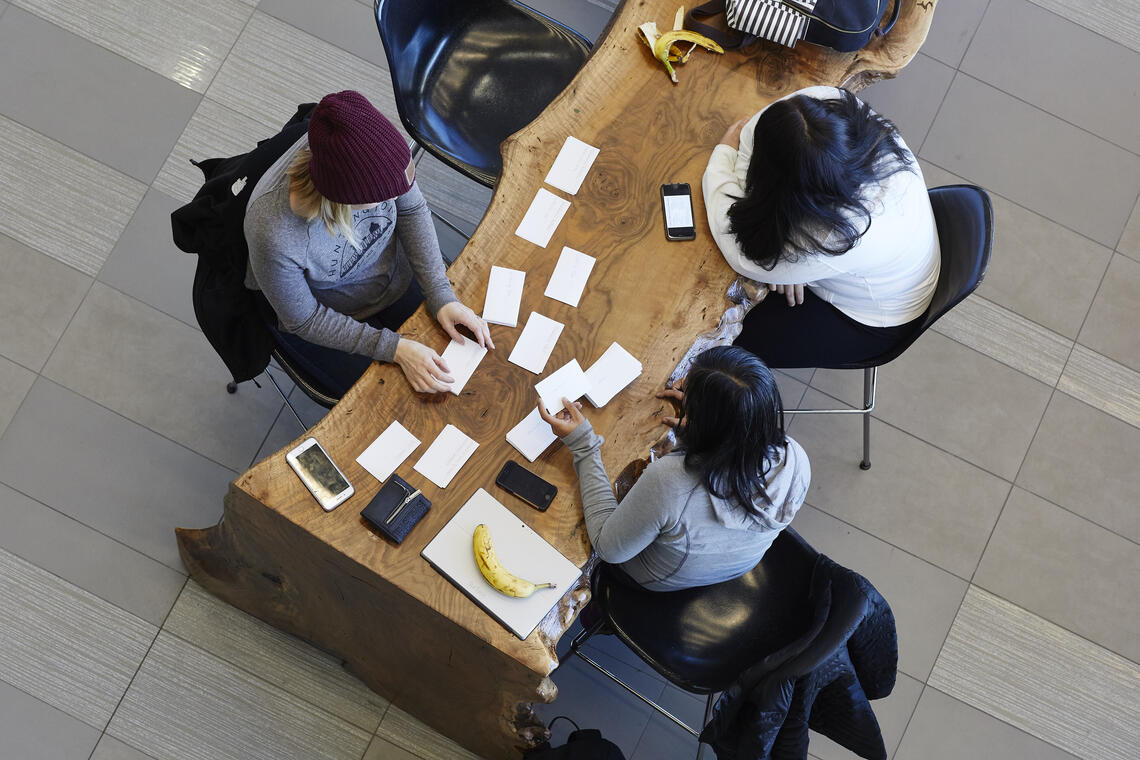 birds eye view of students working on a wooden desk