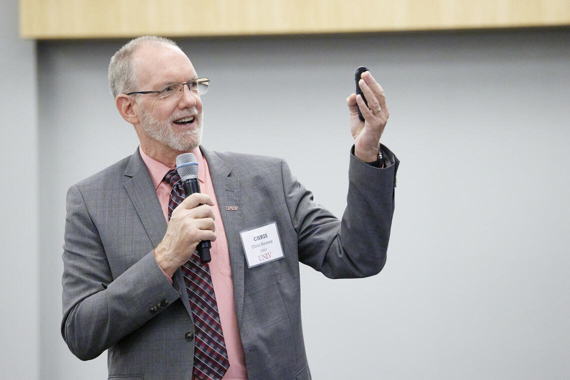 Person giving a speech and raising their hand
