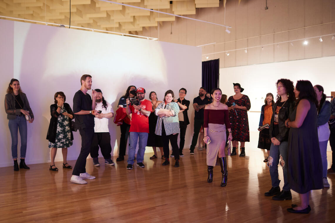 people standing inside a building with projector lights