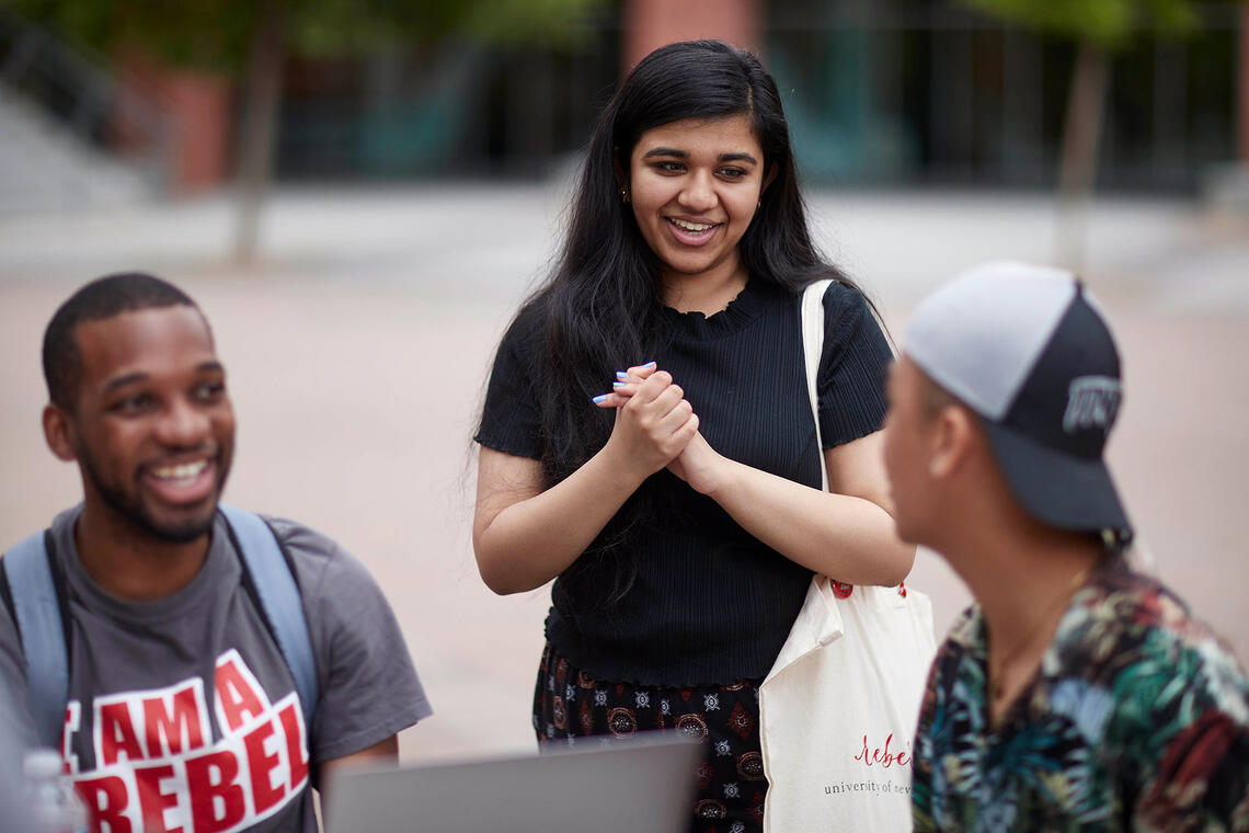 Three students talking to each other