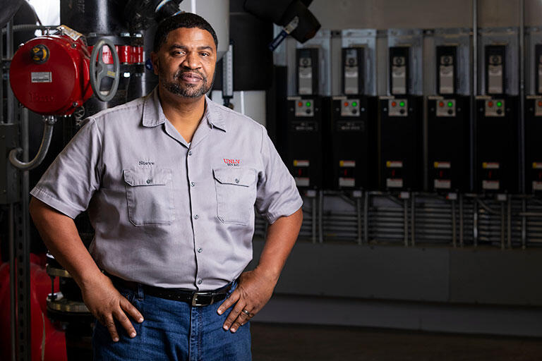 A man in uniform standing with his hands placed at his hips