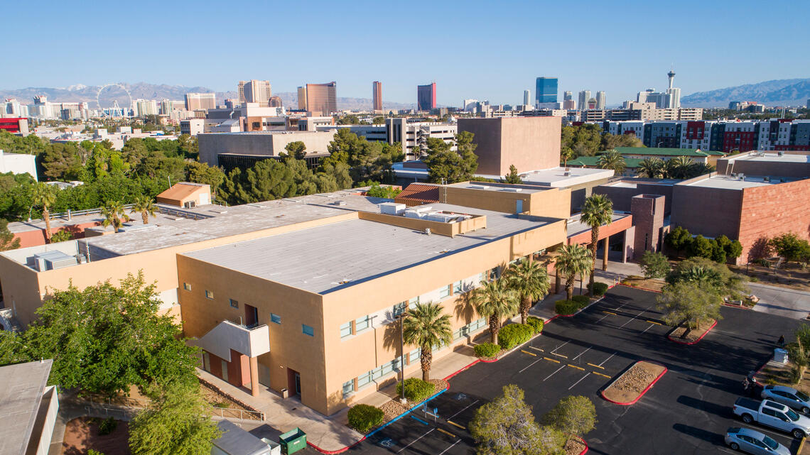 Aerial view of UNLV HFA building with Las Vegas strip in the background.