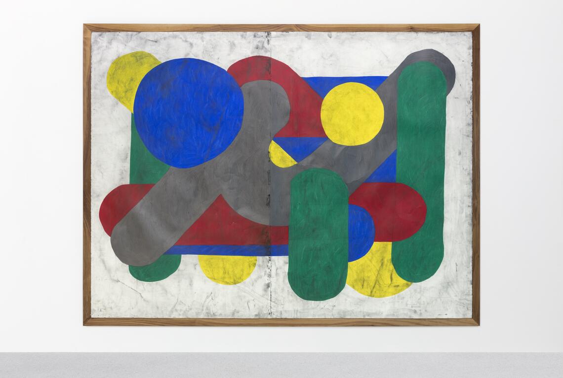An abstract painting of clustered semi-geometric shapes with rounded edges. The shapes are rendered in strong colors: red, blue, green, yellow. The power and simplicity of the shapes is deliberately countered by the somewhat dirtied surface and scuffed paint.