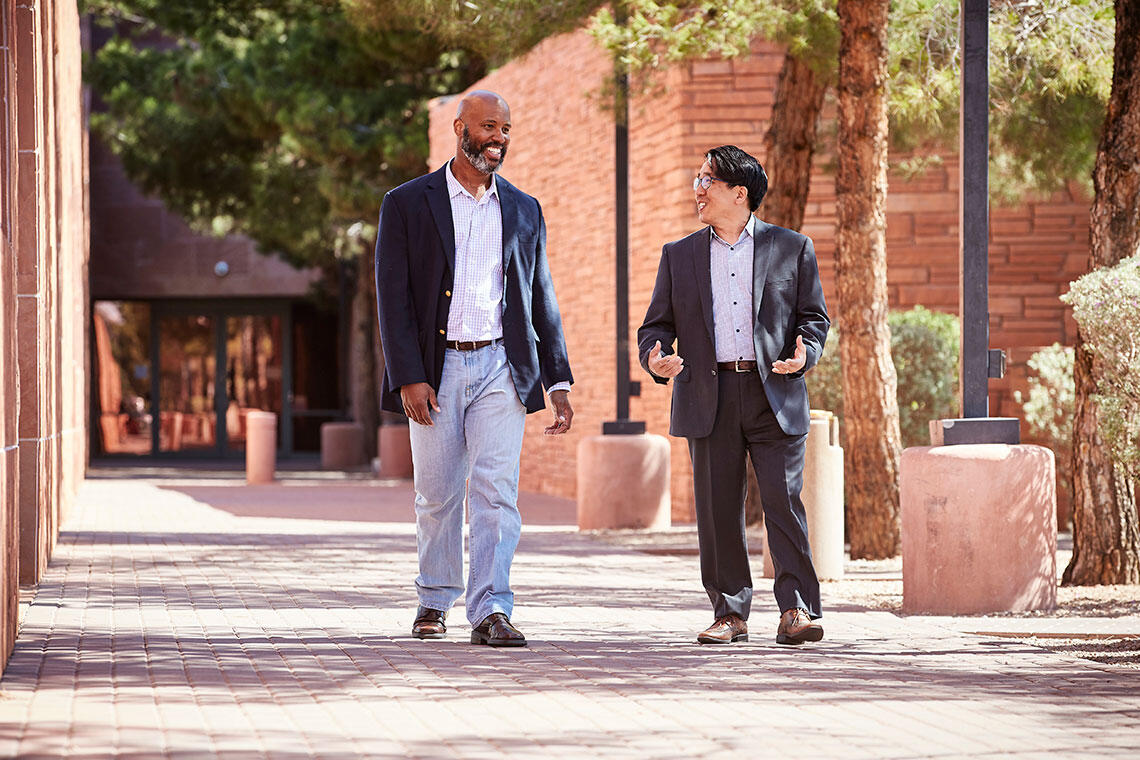 Two men talking to each other outside