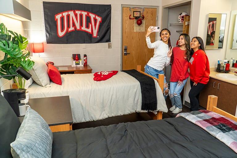 Three students in a dorm room