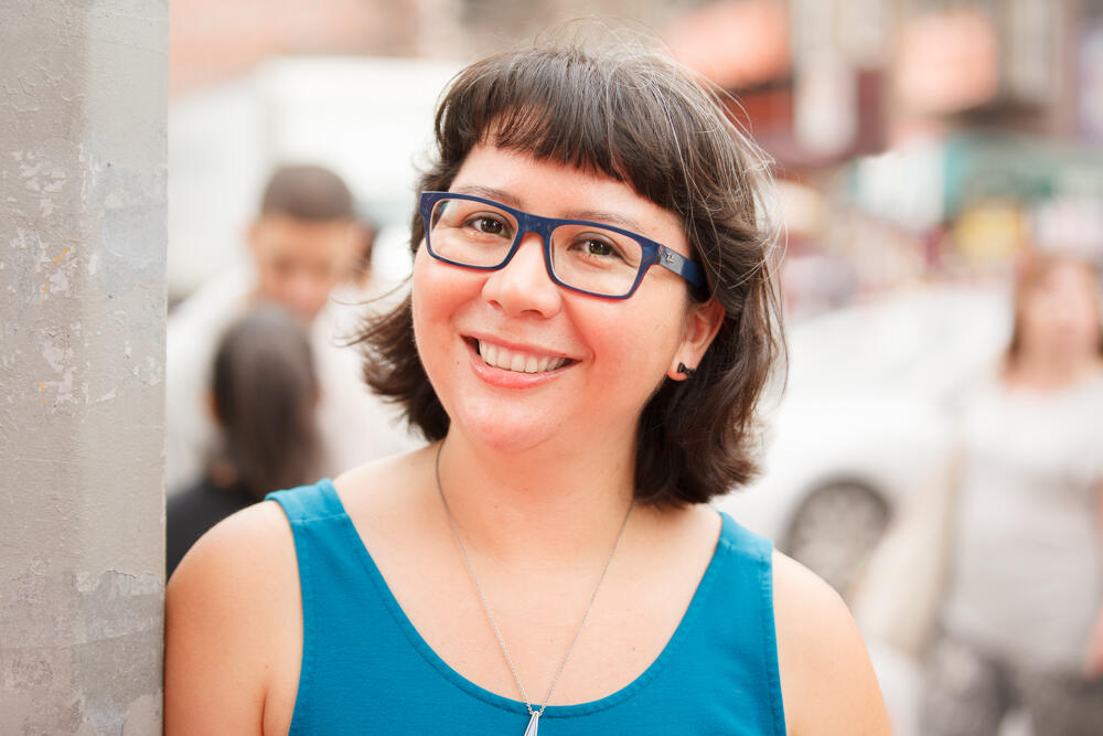 Brunette woman with glasses smiling