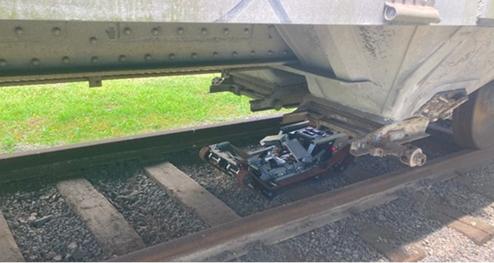Mobile robot inspecting the undercarriage of a rail car