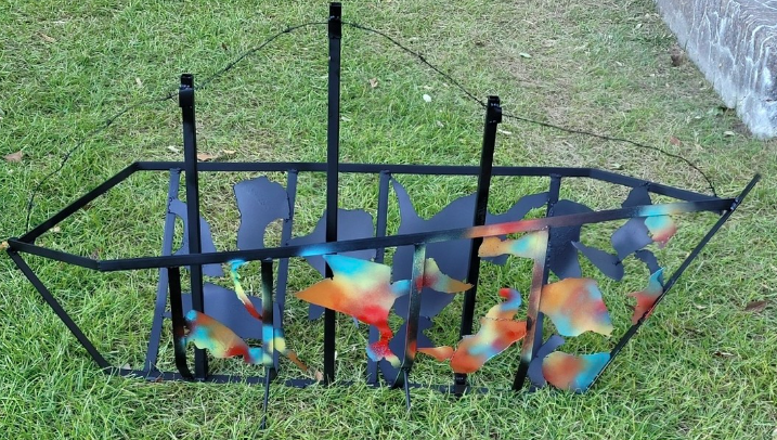 A sculpture of wires with colorful imagery on it 