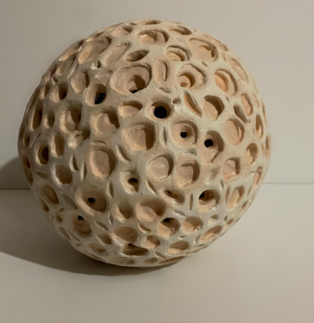 A clay ball with holes in a form of trabeculae