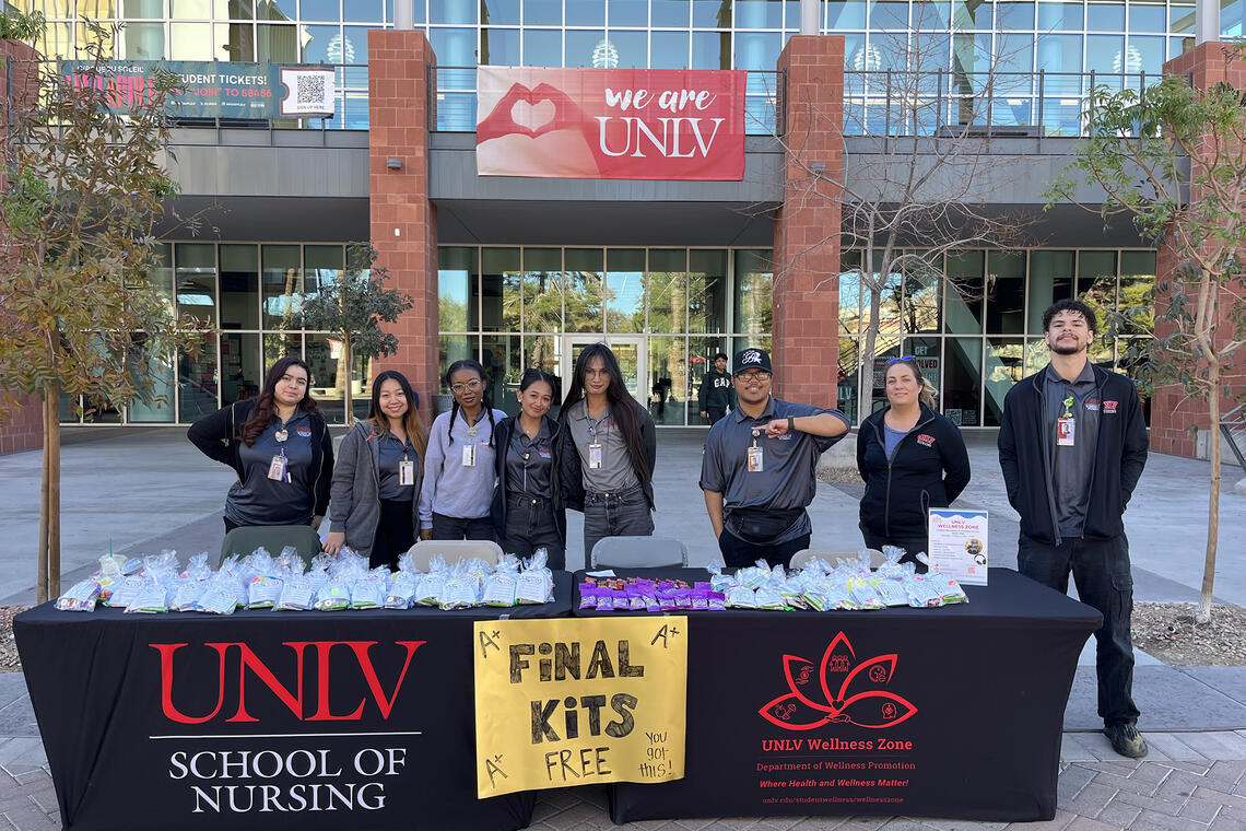 Group of people standing outside the Student Union at a table