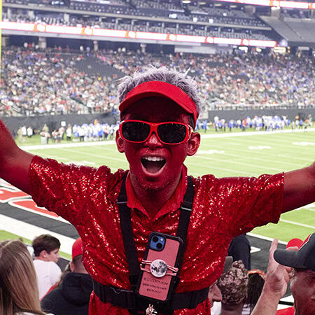 Photo of Lester Cruz covered in red glitter