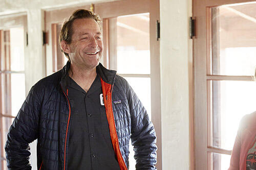 Man smiling while talking to someone off camera