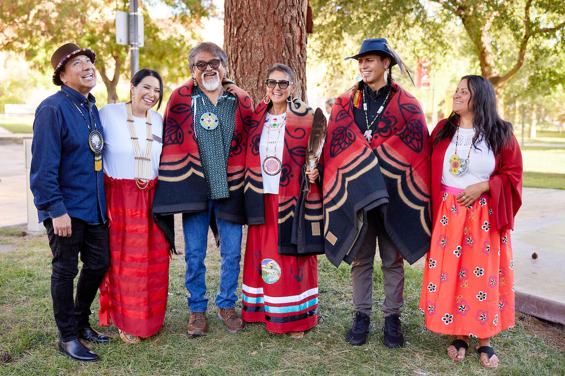 People in traditional clothing posing for a photo