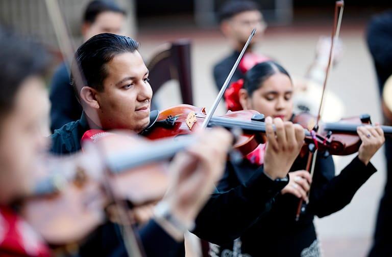 Student musicians playing strings