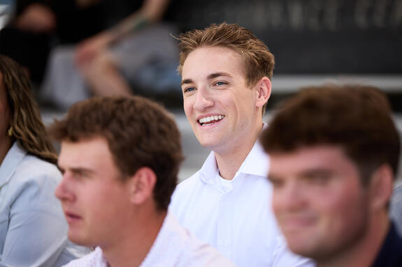 A photo of a student intern sitting in an auditorium