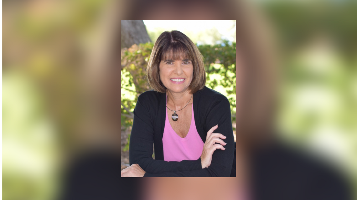 Headshot of woman smiling into the lens.