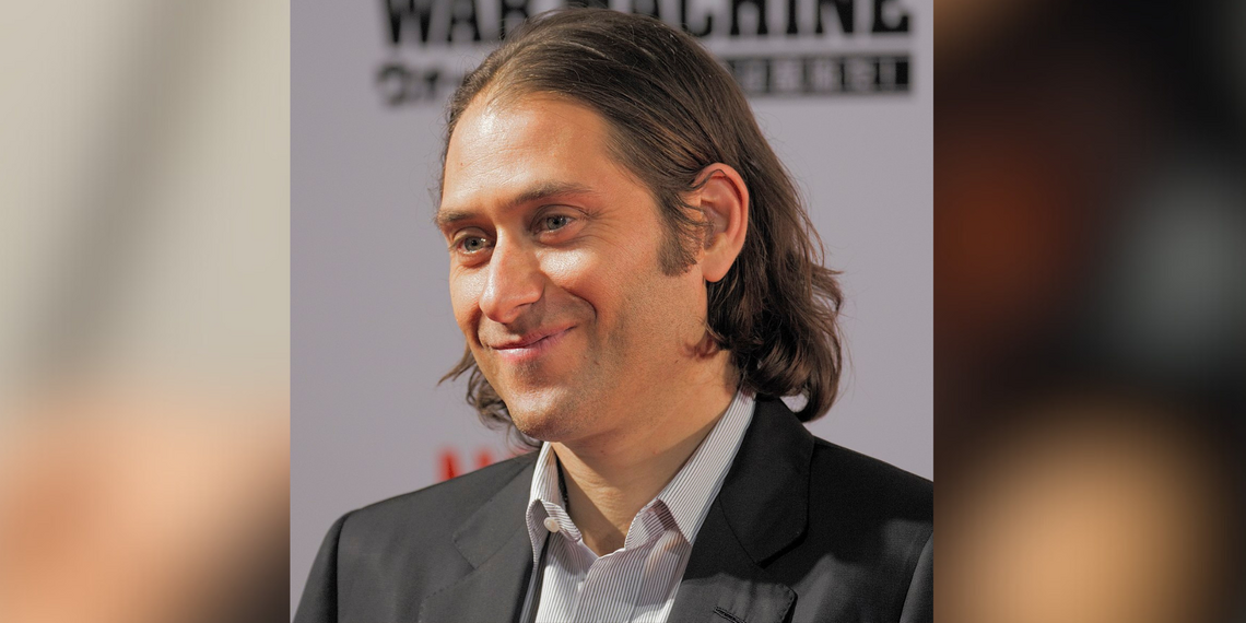 Headshot of Jeremy Kleiner, handsome man with long hair, smiling