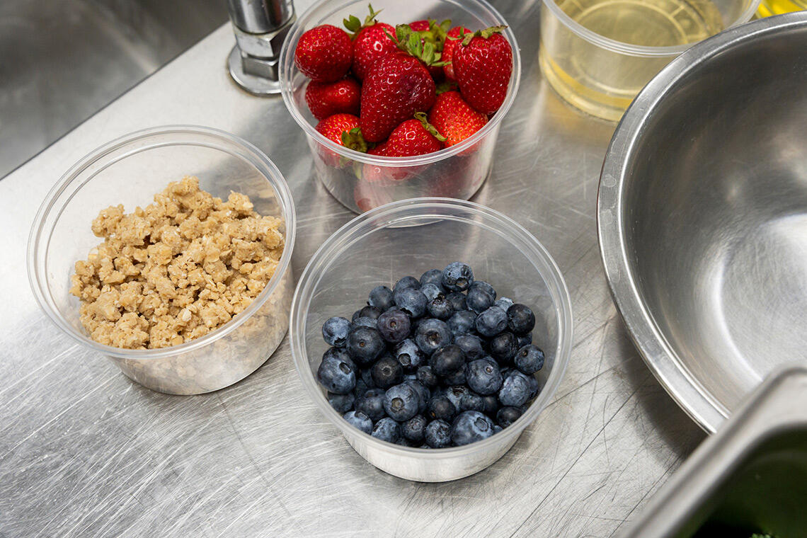 Three bowls of strawberries, oats, and blueberries