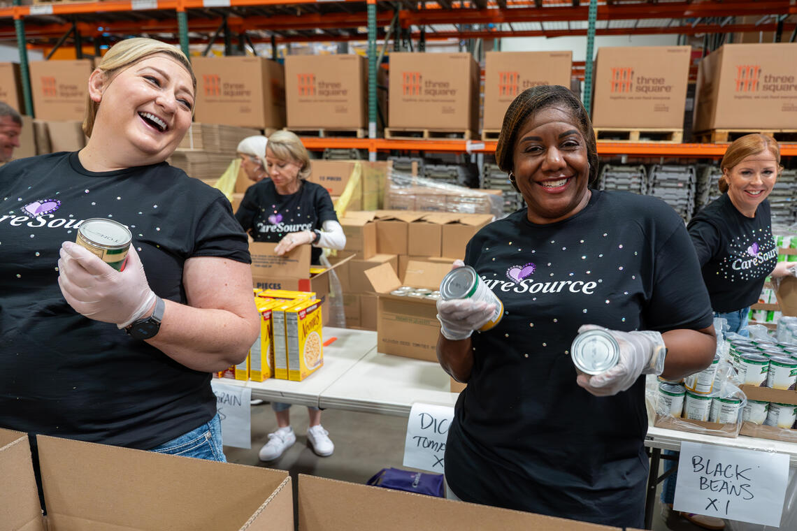 Volunteers from CareSource at Three Square helping prepare food for distribution
