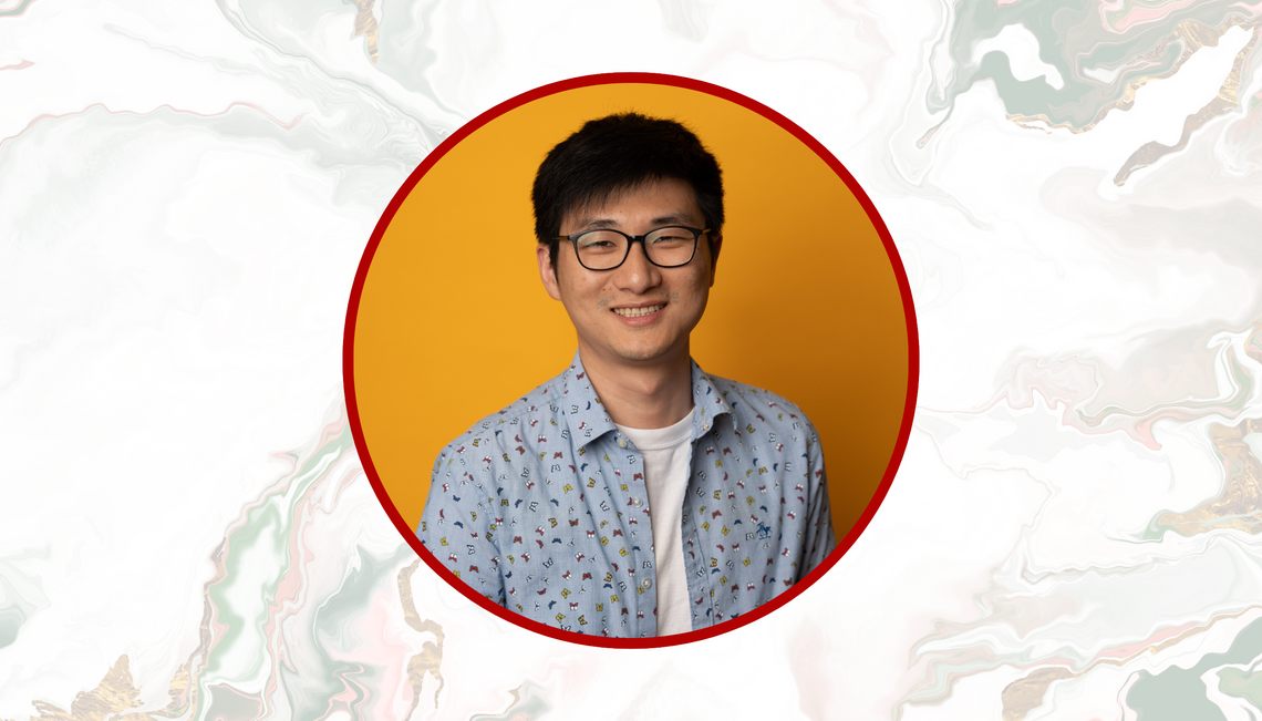 Headshot of dark haired man in glasses: Zida Wang smiling into the camera