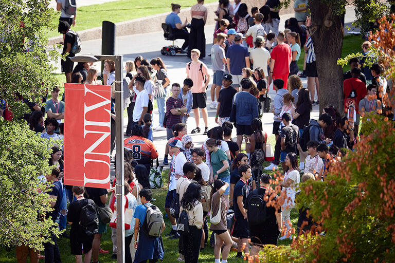 Large group of people walking through the U.N.L.V. academic mall