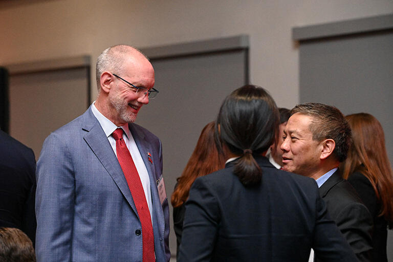 President Heavey speaking with two others