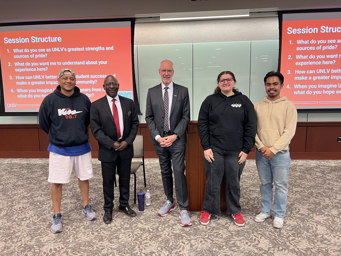 A group of students and President Heavey posing for a photo