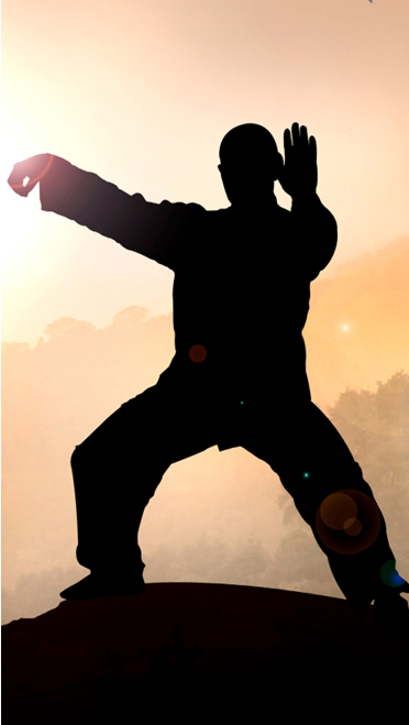 Man performing Taichi in the sunset.