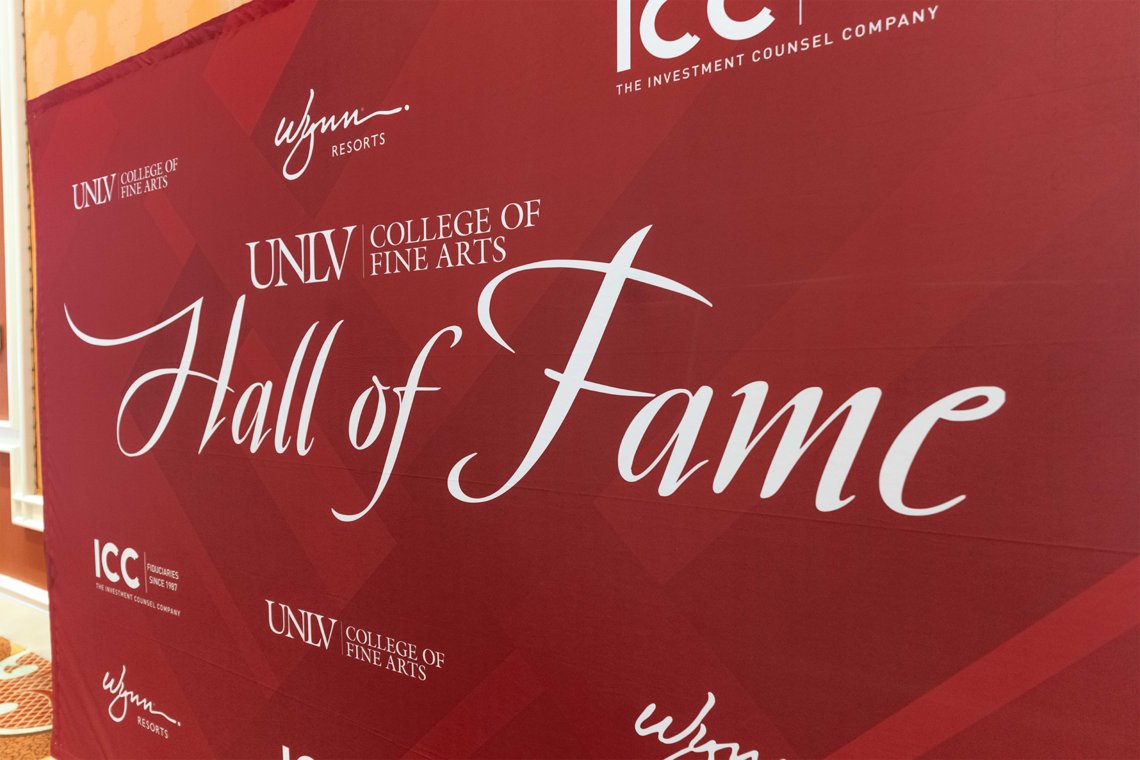 A backboard with the words "U-N-L-V College of Fine Arts Hall of Fame" in the center and names of sponsors surrounding the title in small font
