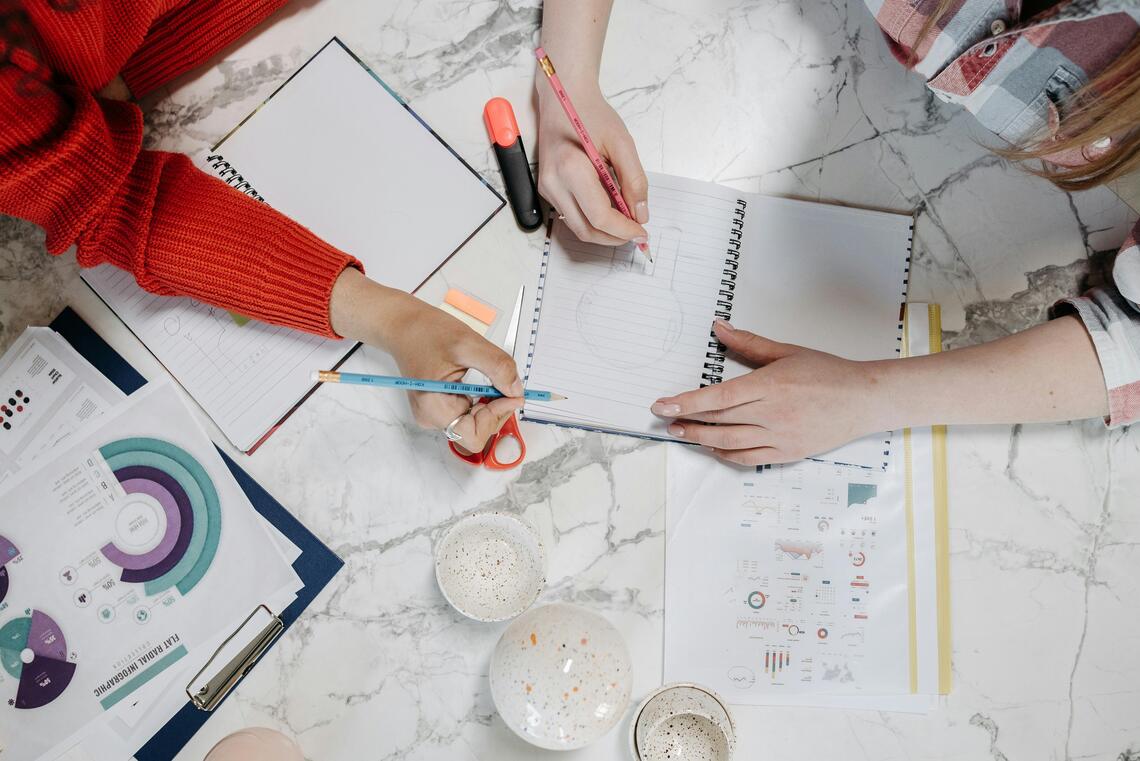 two artists working together drawing an illustration