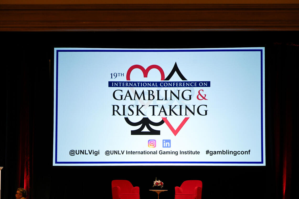 Photo of a slide show showing 'Gambling and Risk Taking'