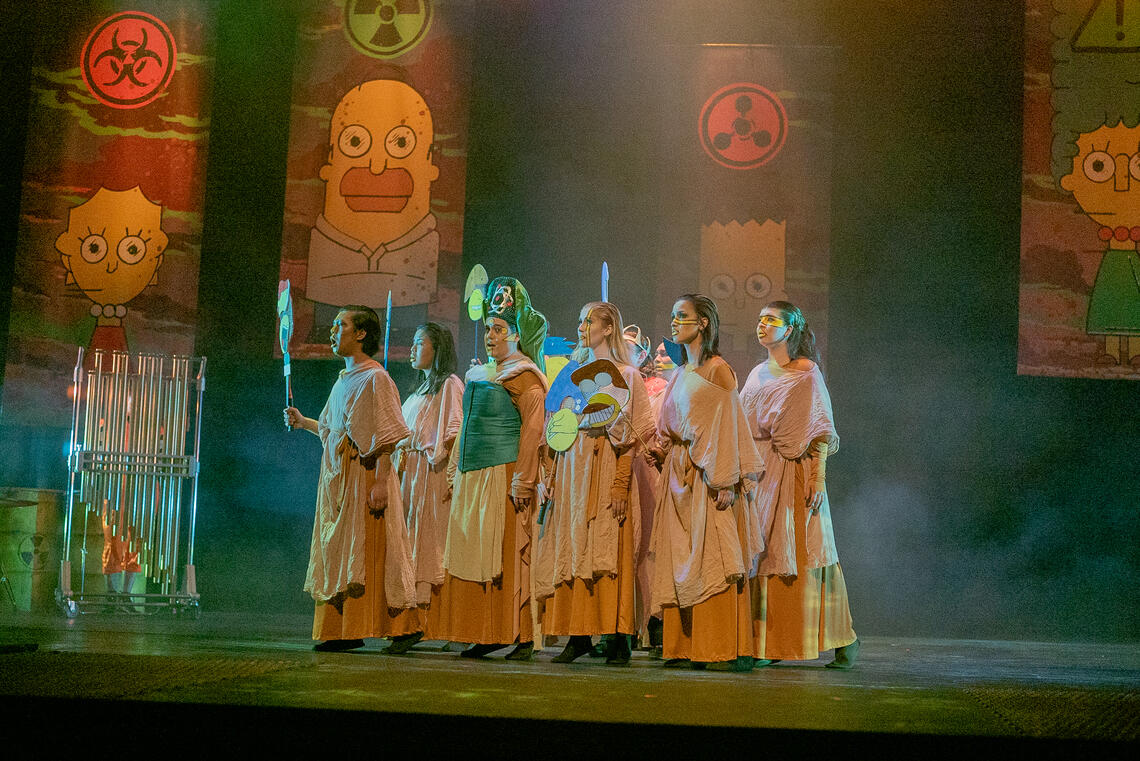 Actors standing on a stage looking out to the distance