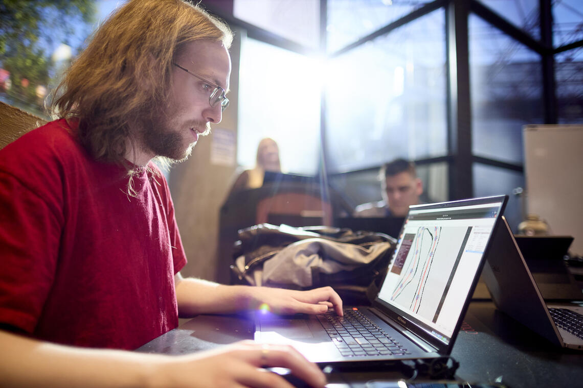 A man sitting at a table with a laptop