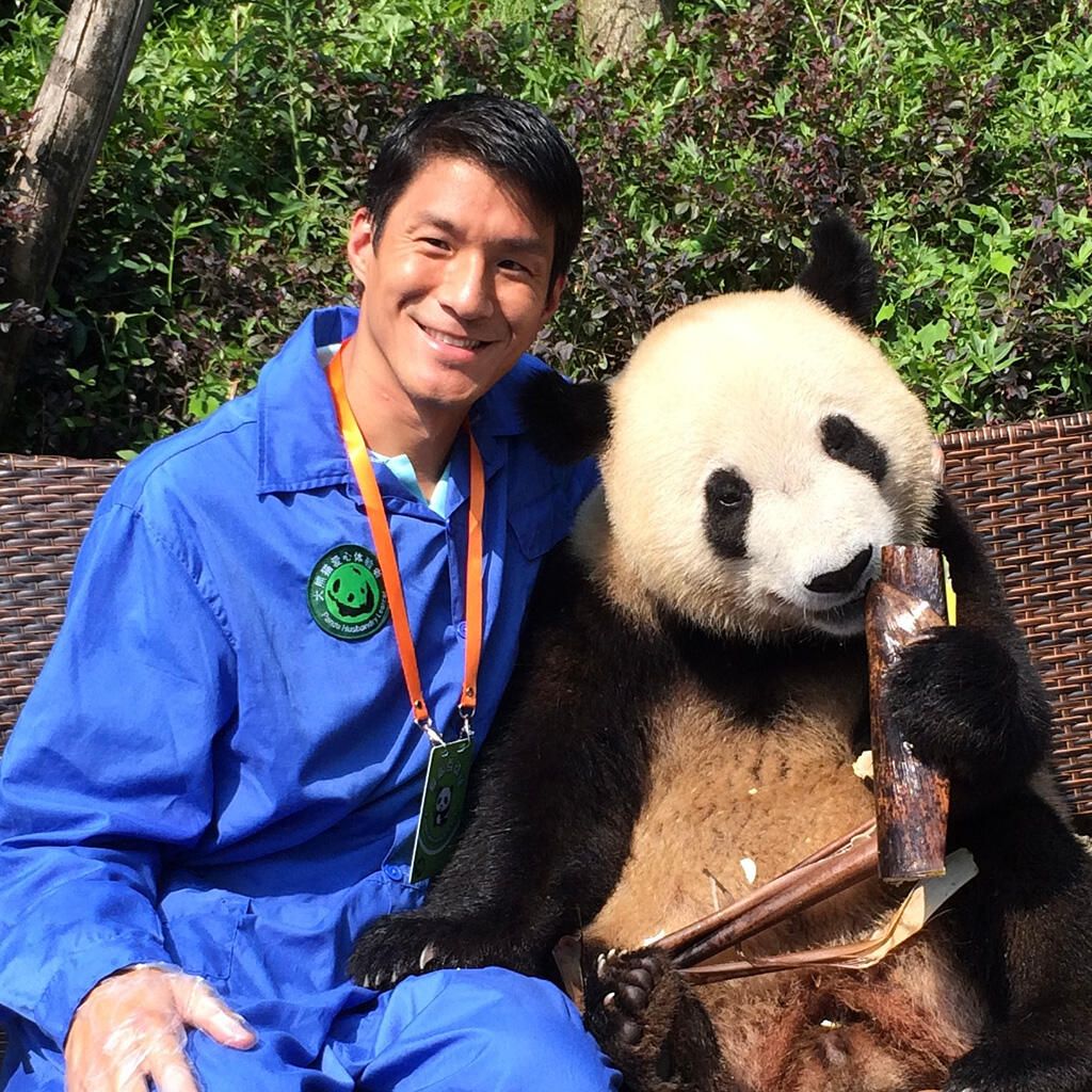 Eric Chiang posing with a panda