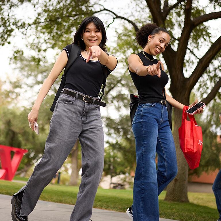 Two students walking on campus