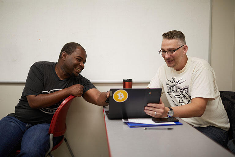 Two people looking at a computer