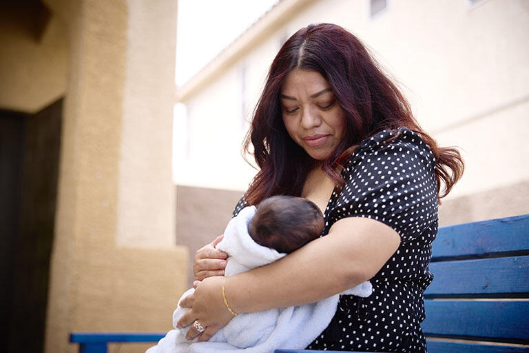 A person breastfeeding their child