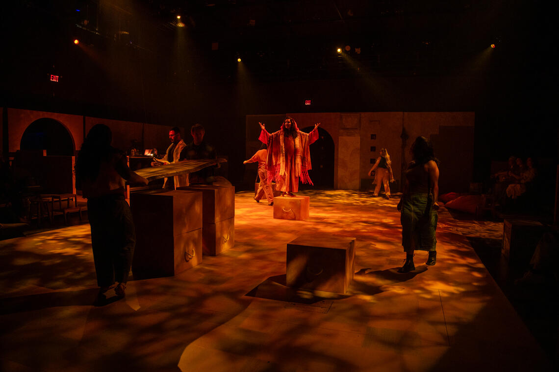 Photo of a well lit stage and actors playing out a scene